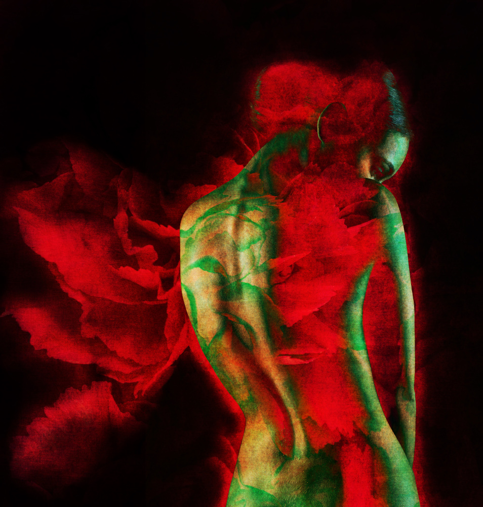 A woman displays vibrant red and green flowers beautifully arranged on her back, showcasing a striking floral design.